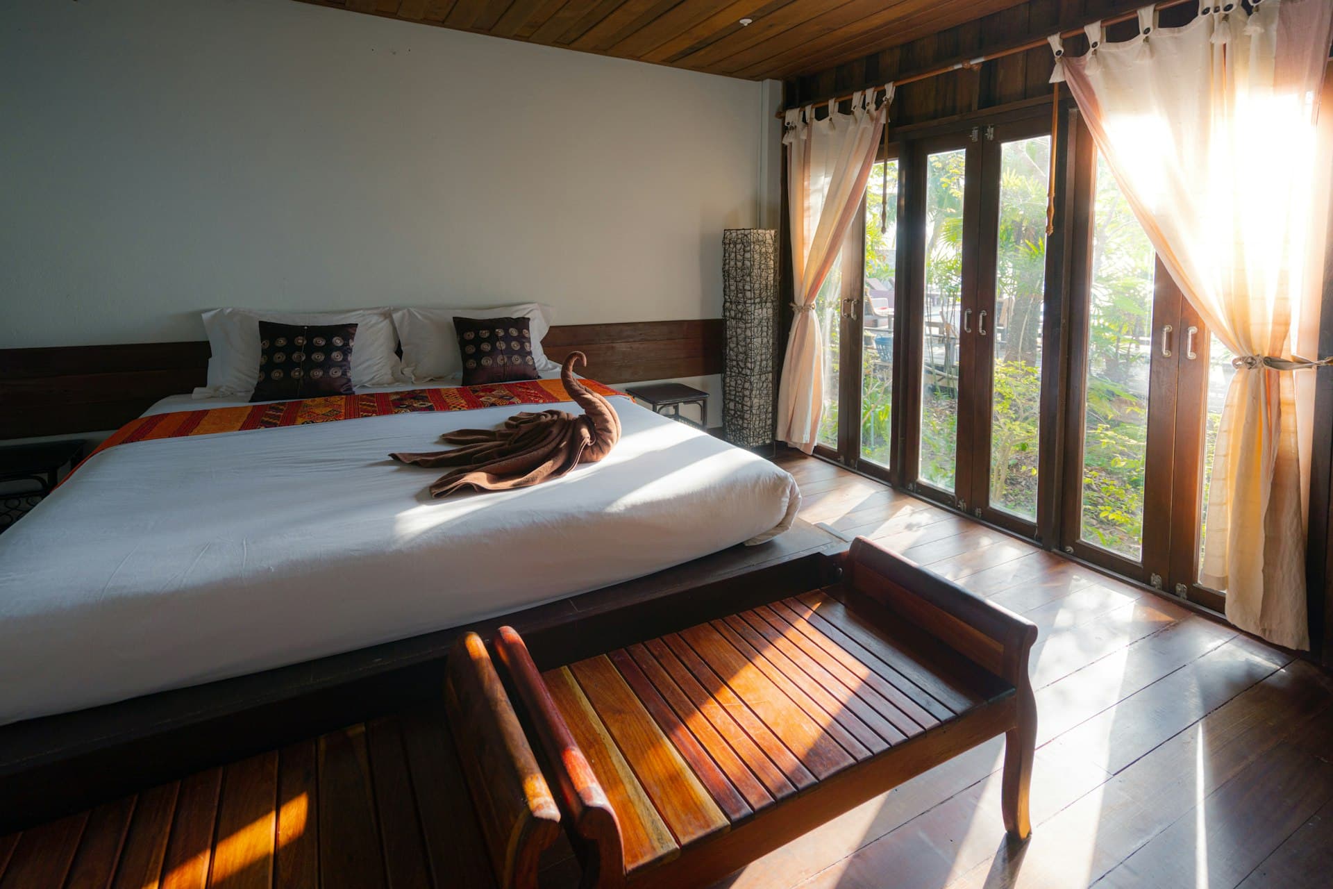 Bedroom with timber furniture and tall windows