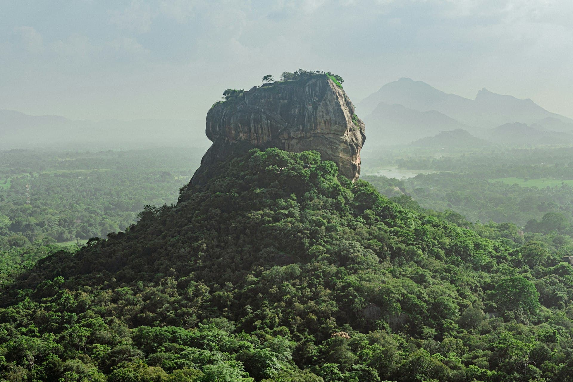 Sigiriya rock rising above forest in Sri Lanka